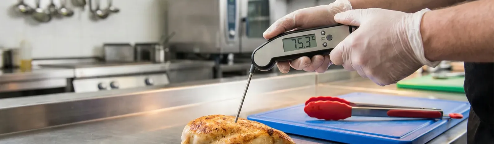 Kitchen manager conducting a hazard analysis walkthrough in a commercial kitchen