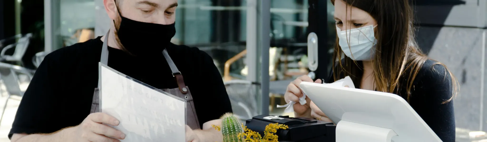 EHO inspector checking temperature records in restaurant kitchen