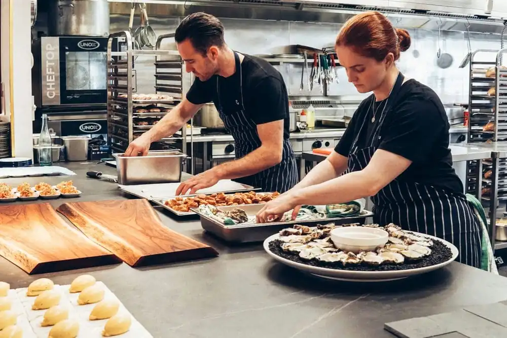 Environmental Health Officer conducting a restaurant kitchen inspection