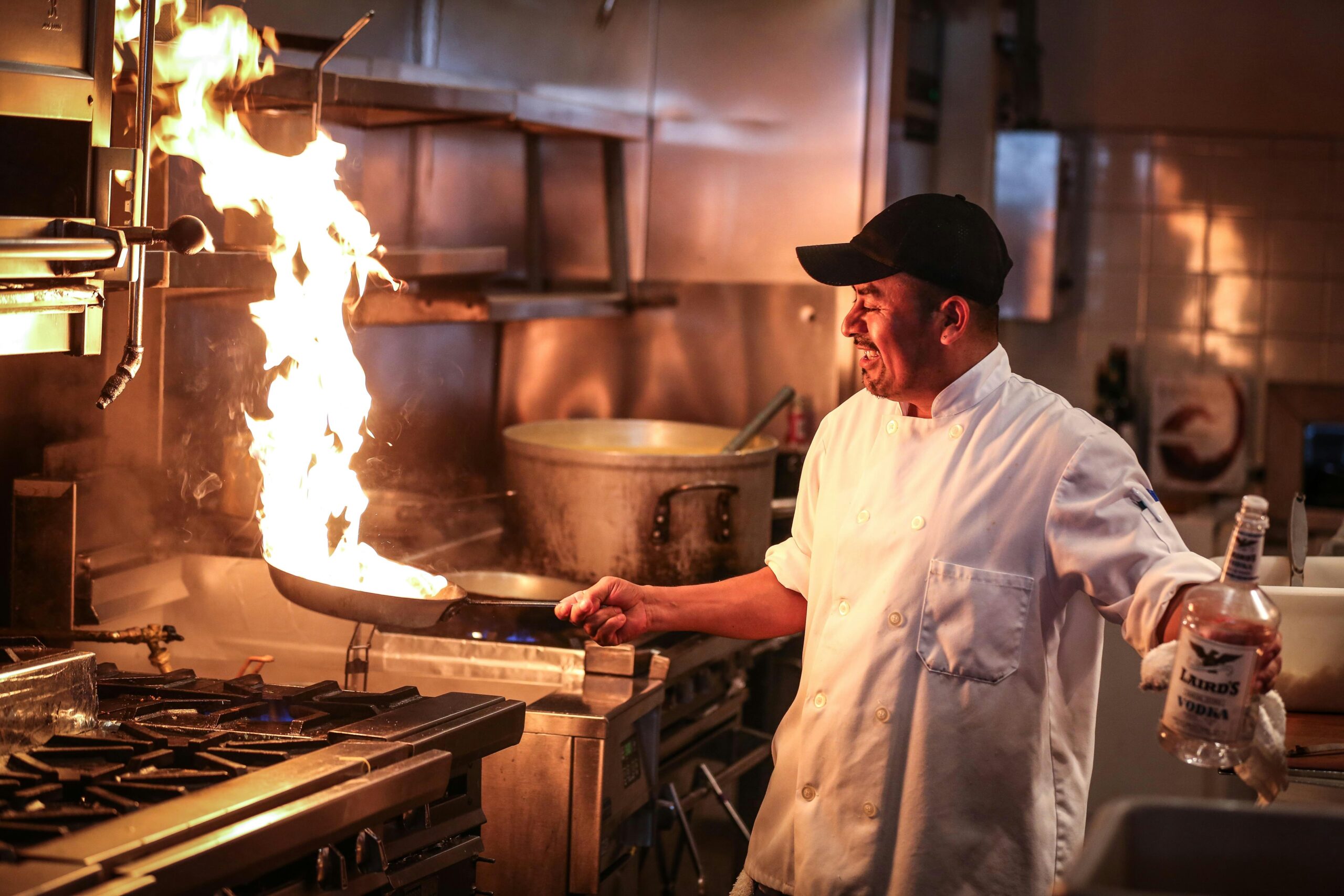 Chef using digital tablet for food temperature recording in a professional kitchen