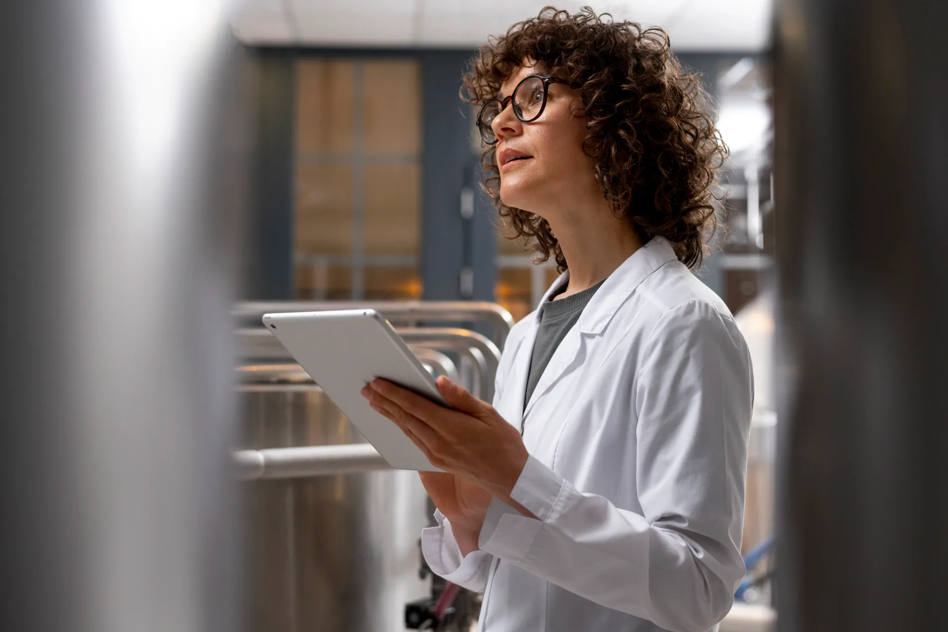 Food business manager reviewing safety documentation in commercial kitchen