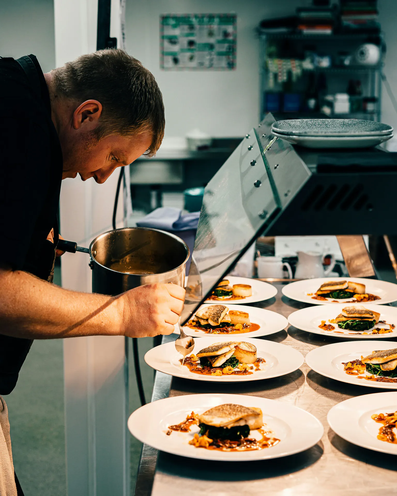 Chef using digital thermometer to check food temperature in professional kitchen